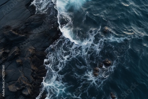Waves crashing against a volcanic shore, view from a drone