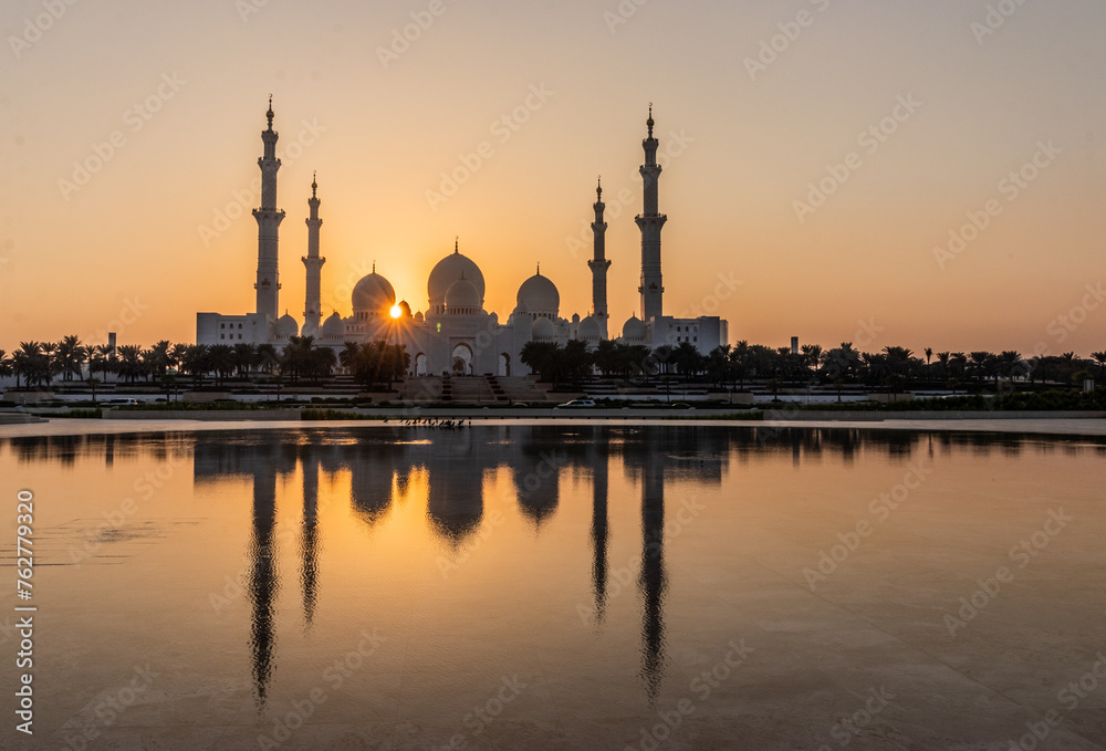 Sunset behind Sheikh Zayed Grand Mosque in Abu Dhabi, United Arab Emirates.