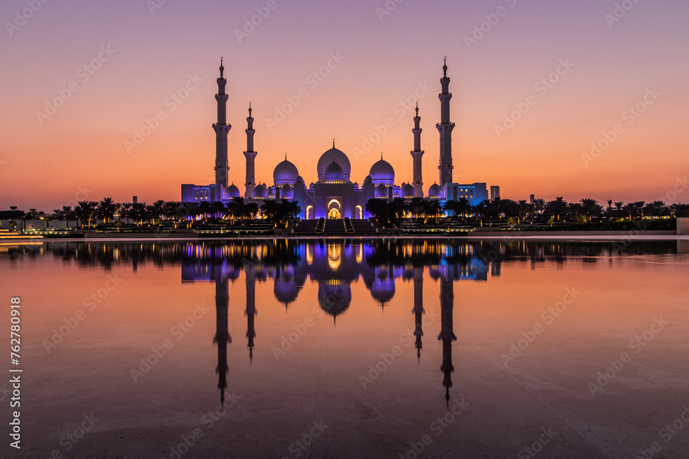 Evening view of Sheikh Zayed Grand Mosque in Abu Dhabi reflecting in a water, United Arab Emirates.