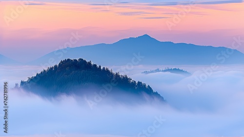 a mountain covered in fog with trees in the foreground and a pink and blue sky with clouds in the background.