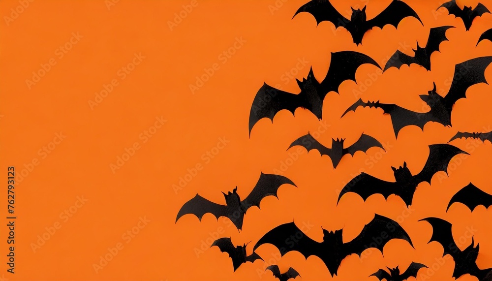 flying flock of bats on orange background mockup halloween holiday concept black silhouettes empty space for text copy space