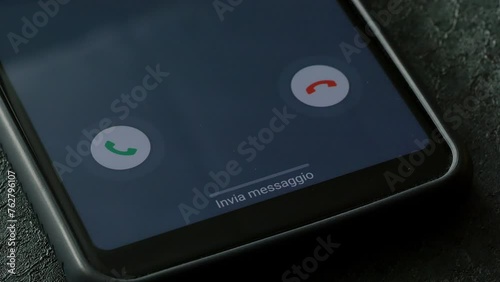 closeup phone with incoming call on the screen over a table