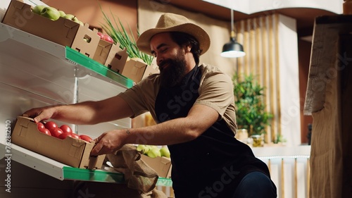 Farmer bringing boxes of fresh produce, restocking local neighborhood grocery shop with vegetables from his own farm. Trader supplying zero waste store with natural food, making client happy