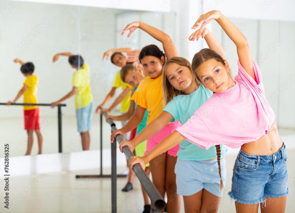 Fototapeta premium Group of children practicing in a ballroom studio