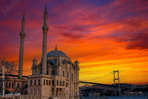 Ortakoy mosque in istanbul with a bridge in the background. Amazing sunset.