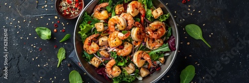 Caesar Salad with Shrimps, Chicken, in Metal Bowler with Sesame Seeds on Dark Stone Background