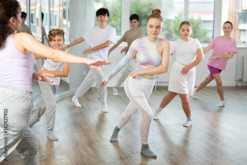 Group of boys and girls rehearsing jazz funk dance in studio