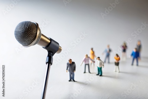 Miniature people. White background. Singer performing in front of a large microphone. photo