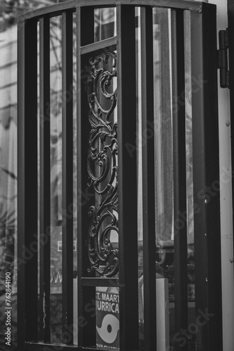 Photography Intricate metal designs stand out against the straight lines of a black railing,