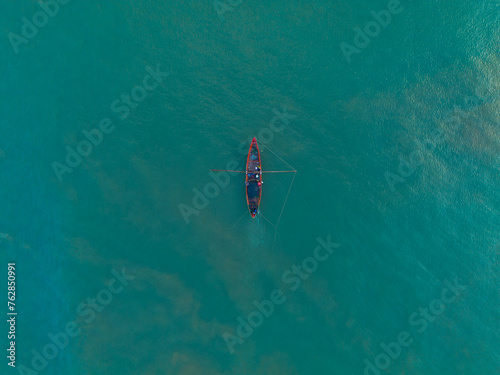 Fishing boat at sea with aerial view looking down. Travel theme background.