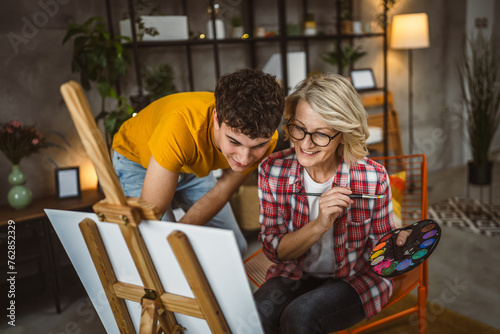 mother and son paint at home mentor artist help teach to create art