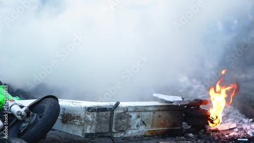 Electric scooter caught fire in the smoky city center - Close shot
