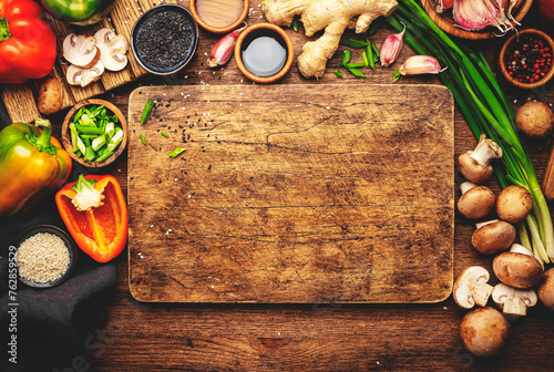 Food and cooking background. Wooden table with vegetables, spices and ingredients for preparing vegetarian Asian dishes with mushrooms and soy sauce. top view, copy space