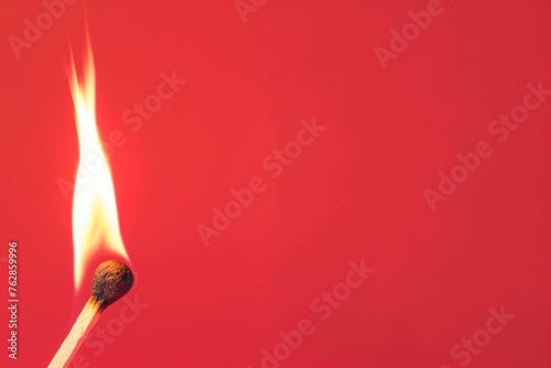 Burning matchstick on a red background