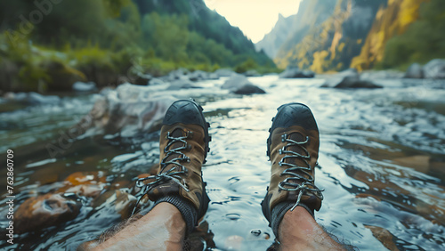 boots of a traveler in a mountainous landscape and a lake