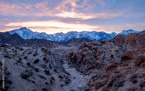 Sunset moment on the mountains with snow and rocks on the foreground photo