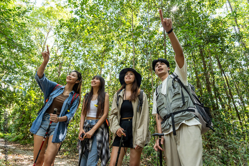 Group of Asian backpacker people having fun travel in forest together. 