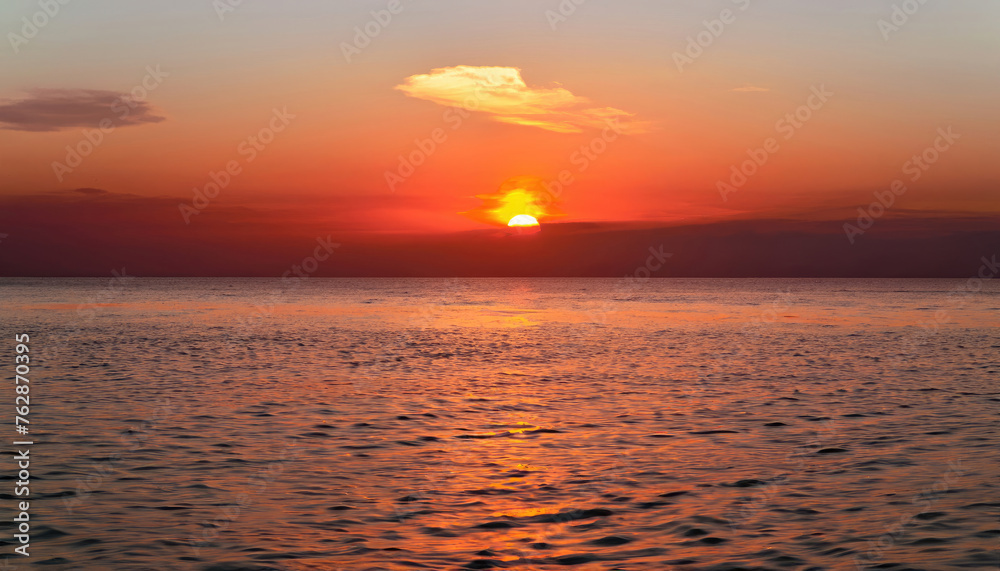Beautiful sunset over the calm surface of the ocean Beautiful sunset over the calm surface of the ocean