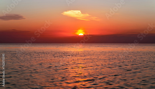 Beautiful sunset over the calm surface of the ocean