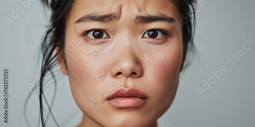 close up portrait of an Asian woman with slightly furrowed eyebrows, generative AI