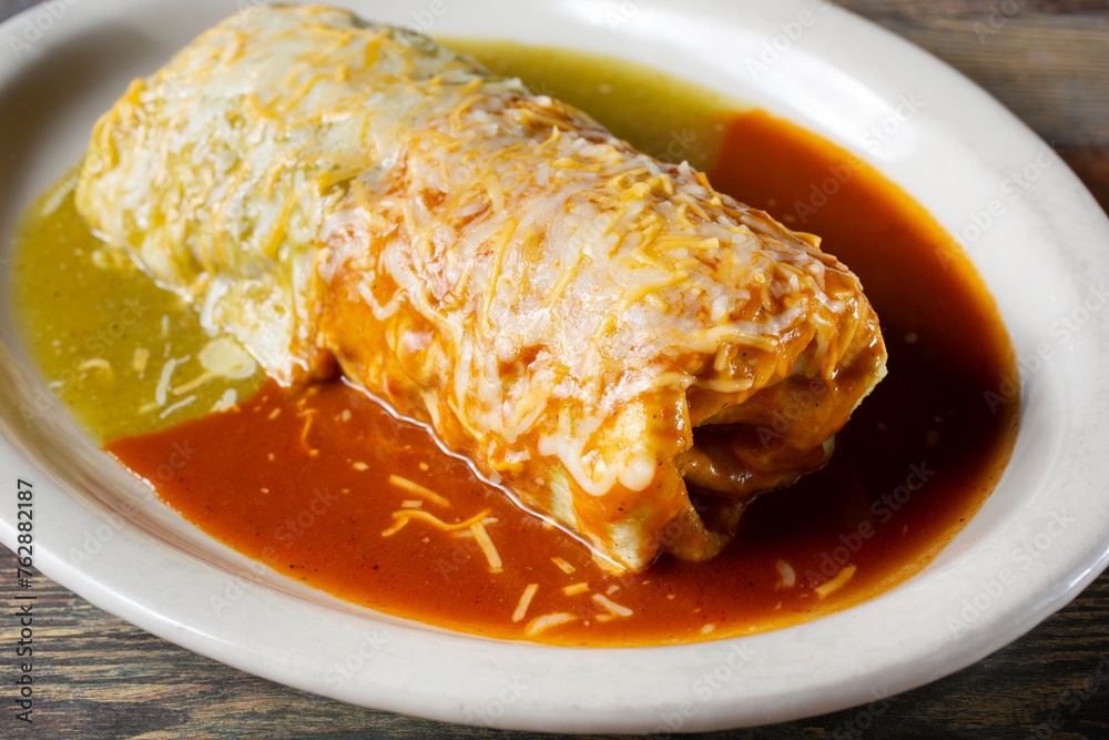 A closeup view of a red and green wet burrito. - obrazy, fototapety, plakaty 