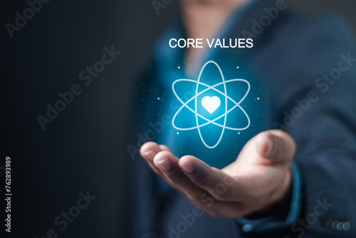 Core values responsibility ethics goals company concept. Businessman holding Core Values icon on virtual screen.