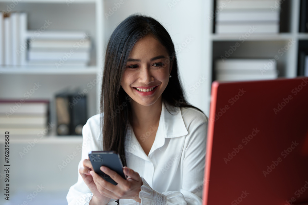Accountant, Asian independent business woman Positive concept using smartphone to relax with mobile app and use chat business communication Contact online marketing that is extremely profitable.