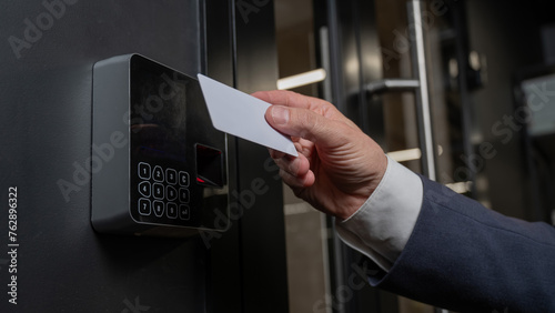 A man opens the door with a card. Modern electronic lock. Keyless Entry photo