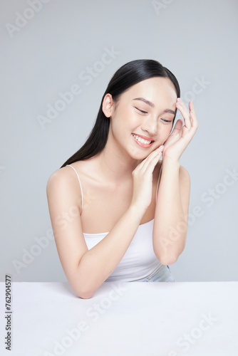 Happy beautiful Asian girl smile and looking to the side. Pretty woman clean fresh skin . Expressive facial expressions .Cosmetology , beauty and Spa