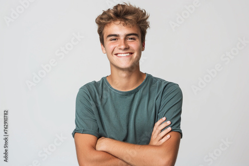 Portrait of handsome smiling young man with folded arms isolated white background.