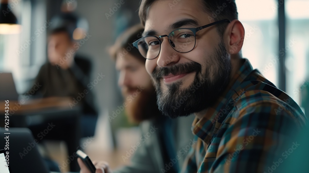 cheerful businessman in eyeglasses typing on laptop while sitting near colleague with mobile phone and bearded man on blurred foreground in lounge of modern coworking space : Generative AI cheerful businessman in eyeglasses typing on laptop while sitting near colleague with mobile phone and bearded man on blurred foreground in lounge of modern coworking space : Generative AI