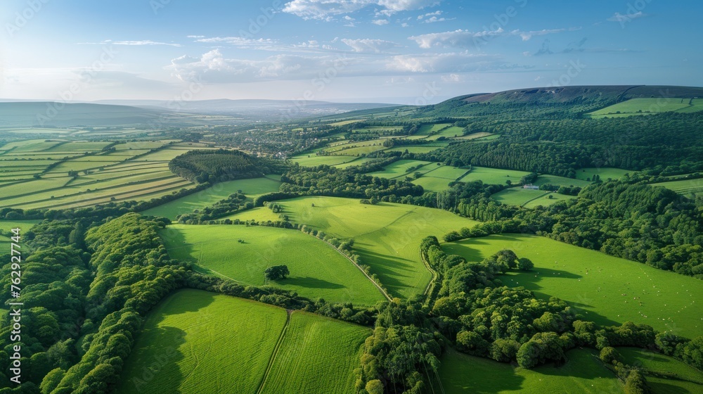 Panoramic view of lush countryside with vibrant green fields from above