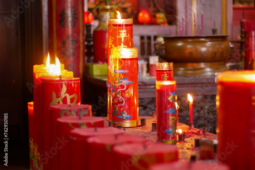 Candles for worship lit in a monastery in Jakarta's Chinatown area. translations: six ways sentient beings photo