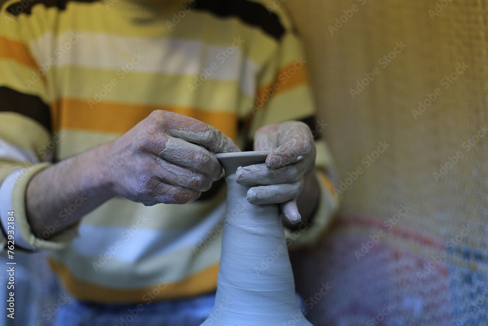 hands of the person making pots