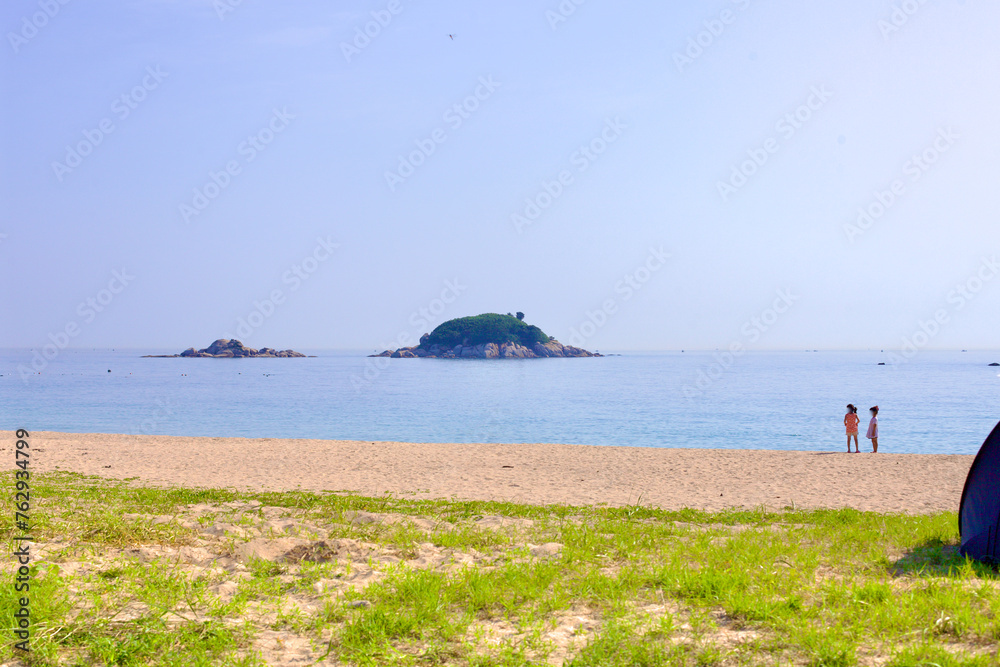 Children on Bongpo Beach with Jukdo Island in the Distance Children on Bongpo Beach with Jukdo Island in the Distance