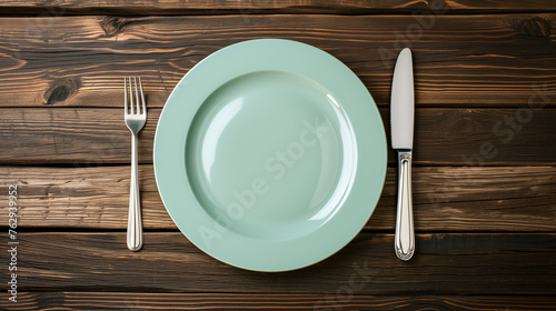 Dinner Setting on Wooden Surface  Knife Fork and Plate.