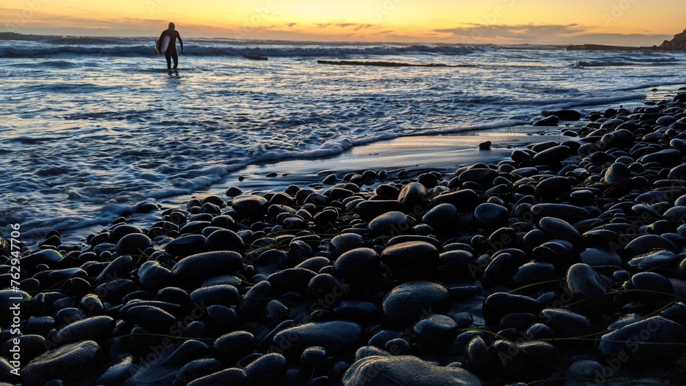 Southern California beach scenes with sunsets, surfers, tide pools and palms trees at Swamis Reef Surf Park and Moonlight Beach in Encinitas California. - obrazy, fototapety, plakaty 