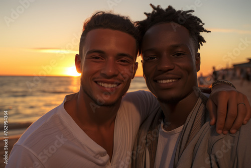Two men are smiling and posing for a picture on a beach