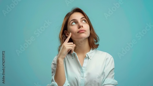Woman Looking Up Thinking Isolated on Studio Background. Copy Space, Think, Thought, Female, Lady, Girl, Idea, Innovation, Finger, Portrait, Business, Hope, Imagine 