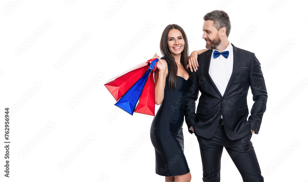 Two man and woman in shop mall. Big sale and shopping with couple. Couple holding shopping bags isolated white. Couple with shopper bags in mall. Purchasing present together. Copy space Two man and woman in shop mall. Big sale and shopping with couple. Couple holding shopping bags isolated white. Couple with shopper bags in mall. Purchasing present together. Copy space