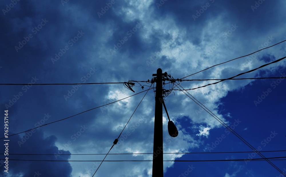 Silhouette of street pole with electrical wires Silhouette of street pole with electrical wires