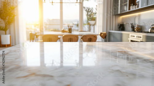 White marble textured empty counter top against blurred modern kitchen background, sunlight coming from open window © amila