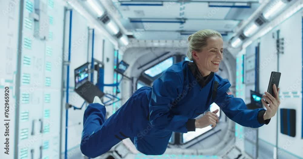 Woman in Space Talking on a Phone While Holding on to a Satellite. Astronaut Chatting with Mission Control, Family or Work Colleagues on a Video Call App on a Smartphone Woman in Space Talking on a Phone While Holding on to a Satellite. Astronaut Chatting with Mission Control, Family or Work Colleagues on a Video Call App on a Smartphone