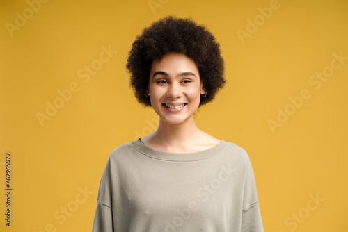 Happy, beautiful cute African American woman with curly hair looking at camera © Maria Vitkovska