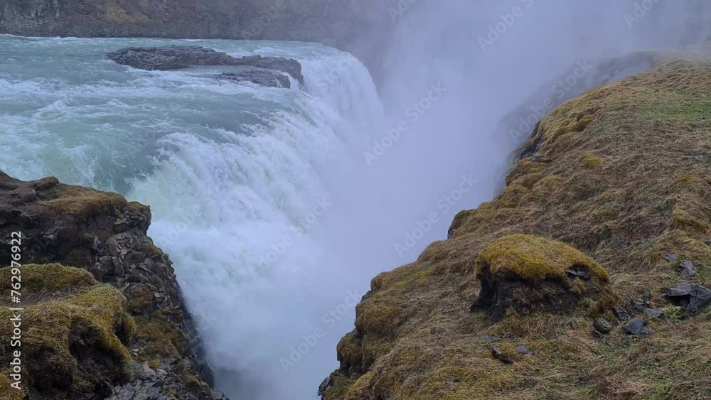 Powerful Waterfall in Landscape of Iceland, Glacial Water Flowing Into Deep Narrow Canyon Powerful Waterfall in Landscape of Iceland, Glacial Water Flowing Into Deep Narrow Canyon
