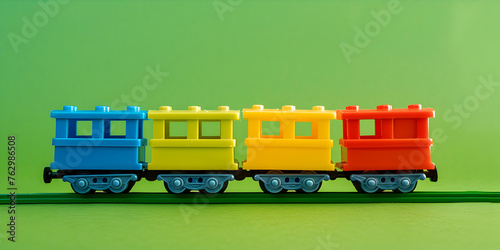 Colorful plastic  Toy Train on a bright green background the plastic train toy for children in transportation items   photo