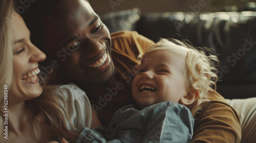 Portrait of a interracial family with parents and their young toddler kid at happy home photo