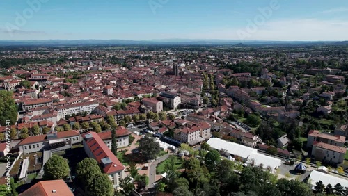 backward aerial shot over the city of Montbrison in Loire departement, french countryside on a sunny day photo