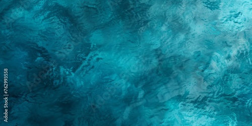 Textured abstract background in shades of blue resembling watercolor brush strokes or underwater patterns.