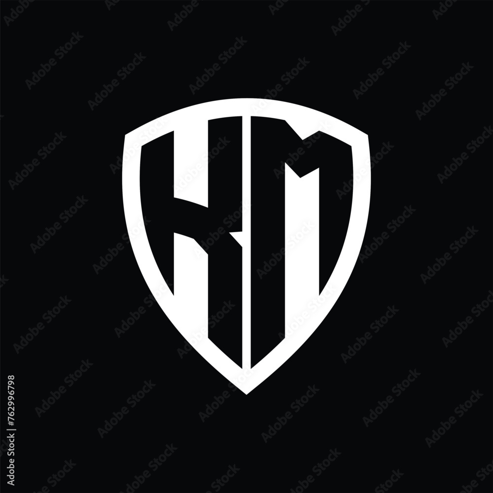 KM monogram logo with bold letters shield shape with black and white color design KM monogram logo with bold letters shield shape with black and white color design